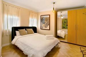 a bedroom with a large bed and a mirror at Ocean Side Arinaga in Arinaga