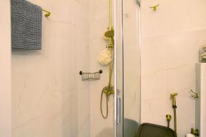 a bathroom with a shower with a glass door at Ocean Side Arinaga in Arinaga +11 photos