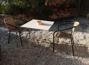 two chairs and a white table with a cup on it at La Grange De Vauviault in Bressuire