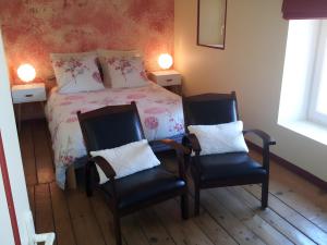 a bedroom with a bed and two chairs at La Grange De Vauviault in Bressuire +11 photos