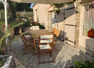 a patio with a table and chairs on a patio at La Grange De Vauviault in Bressuire