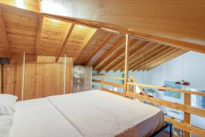 a bedroom with a bed and wooden ceilings at Zoe apartment in Marantochori