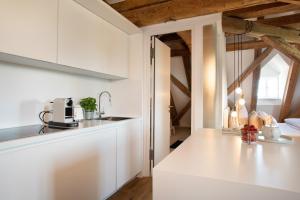 a kitchen with white cabinets and a counter top at Schloss Kirchberg - Schlossnest in Immenstaad am Bodensee
