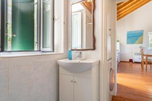 a bathroom with a sink and a mirror at Zoe apartment in Marantochori