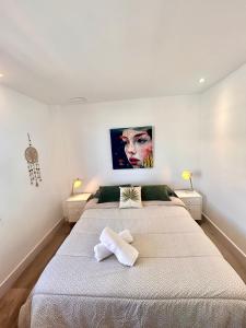 a bedroom with a large bed with two towels on it at Sueña Mar Luxury Suites in Torrevieja +34 photos