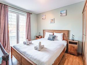 a bedroom with a large bed and a window at Apartment Zandloper with balcony by Interhome in Bredene