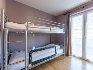 a bedroom with bunk beds in a room with a window at Apartment Zandloper with balcony by Interhome in Bredene +8 photos
