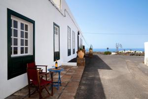 a table and chairs sitting on the side of a building at El Cello in Mácher +12 photos
