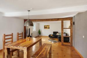 a living room with a wooden table and a couch at You R Welcome in Lauterbach