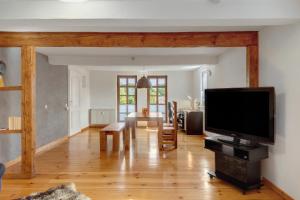 a living room with a large flat screen tv at You R Welcome in Lauterbach