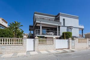 a house on a street with a fence at Carmen in Oliva