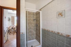 a bathroom with a shower with a glass door at Le Mimose Bilo4 bis in Imperia +18 photos