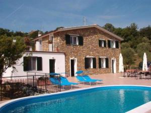 a house with a swimming pool in front of a house at Le Mimose Bilo4 bis in Imperia