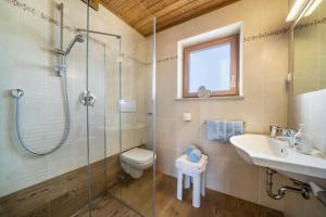 a bathroom with a shower and a toilet and a sink at Ferienwohnung Mittager Edelweiss in Avelengo +9 photos