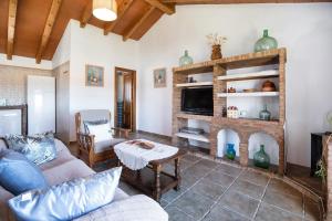 a living room with a couch and a fireplace at Casa Andrea in Barbate