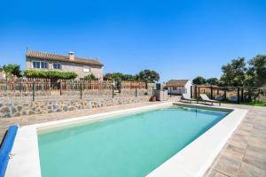 a swimming pool in front of a house at Casa Andrea in Barbate