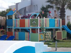 a childrens play area with a playground with books at Hippokratis Apartments in Gerani