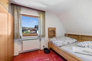 a bedroom with a bed and a window at Haus an der Lauchert in Veringenstadt