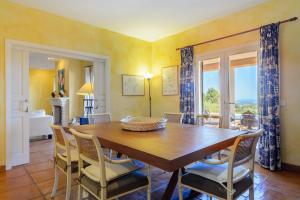 a dining room with a wooden table and chairs at Can Roca in Illes Balears