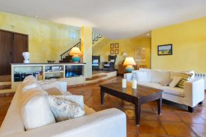 a living room with white couches and a coffee table at Can Roca in Illes Balears