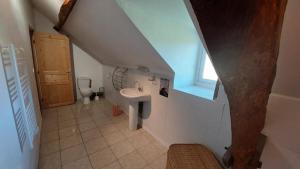 an attic bathroom with a sink and a toilet at Maison de Vacances Chez La Prade in Salagnac +18 photos