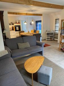 a living room with a couch and a table at Haus Königsfeld in Hage