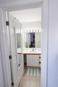 a bathroom with a sink and a mirror at Passive Stays Mountain Home 2BR in Mountain Home +12 photos