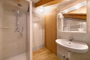 a bathroom with a sink and a shower at Residence Montebel Studio in Tesero +19 photos