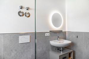 a bathroom with a sink and a glass shower at Beim Klarwein in Farchant +17 photos