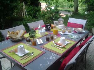 a picnic table with food and utensils on it at Villa Gastandeia in Cambo-les-Bains