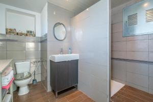 a bathroom with a toilet and a sink and a mirror at Maison Mer Peniscola in Peniscola +15 photos