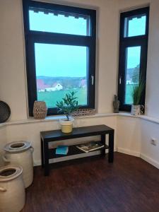 a living room with a table and a window at Sonnige Ferienwohnung Am Sternberg in Extertal +32 photos