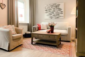 a living room with a couch and a coffee table at Ferienwohnung Gut Börtewitz in Leisnig +19 photos