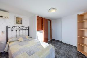 a bedroom with a bed in a room with shelves at Villa Loli 2 in El Pozo de los Frailes