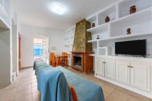 a living room with a flat screen tv and a couch at Villa Loli 2 in El Pozo de los Frailes