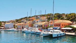 a group of boats docked in a harbor with buildings at Jenny Apartment in Gaios +3 photos