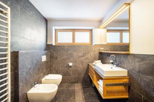 a bathroom with a sink and a toilet at App Hubertus - Wasserfallspitz in Sand in Taufers +29 photos