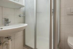 a bathroom with a sink and a shower at App Sonne Nr 18 in Lutago +13 photos