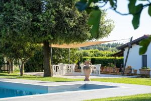 a pool in a yard with a table and chairs at I Profumi Dell'Orto - Campagnatico in Campagnatico