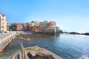 a group of buildings on the side of a body of water at Il ciliegio di Miki in Genoa