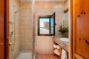 a bathroom with a tub and a sink and a mirror at Ran de Mar in Son Serra de Marina