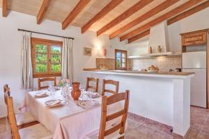 a kitchen and dining room with a table and chairs at Villa Joana in Pollença