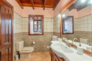 a bathroom with a toilet and a sink at Gran Drago in Valverde +19 photos