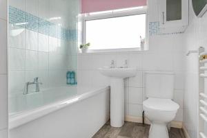 a white bathroom with a sink and a toilet at Stainorstarve in London