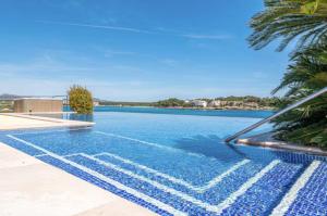 a swimming pool with a view of the water at Sa Bateria in Portocolom
