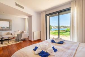 a bedroom with a bed with a view of the ocean at Sa Bateria in Portocolom +22 photos
