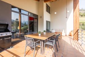 a dining room with a wooden table and chairs at La Riega Del Peral in Ojedo +23 photos