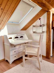 a room with a desk and a table and a chair at Kleines Eifel Backhaus mit Sauna in Feuerscheid
