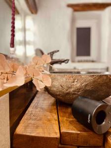 a wooden counter with a sink and a wooden bowl at Kleines Eifel Backhaus mit Sauna in Feuerscheid +34 photos