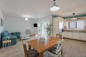 a kitchen and a living room with a wooden table at Casa Elvira in Frontera
